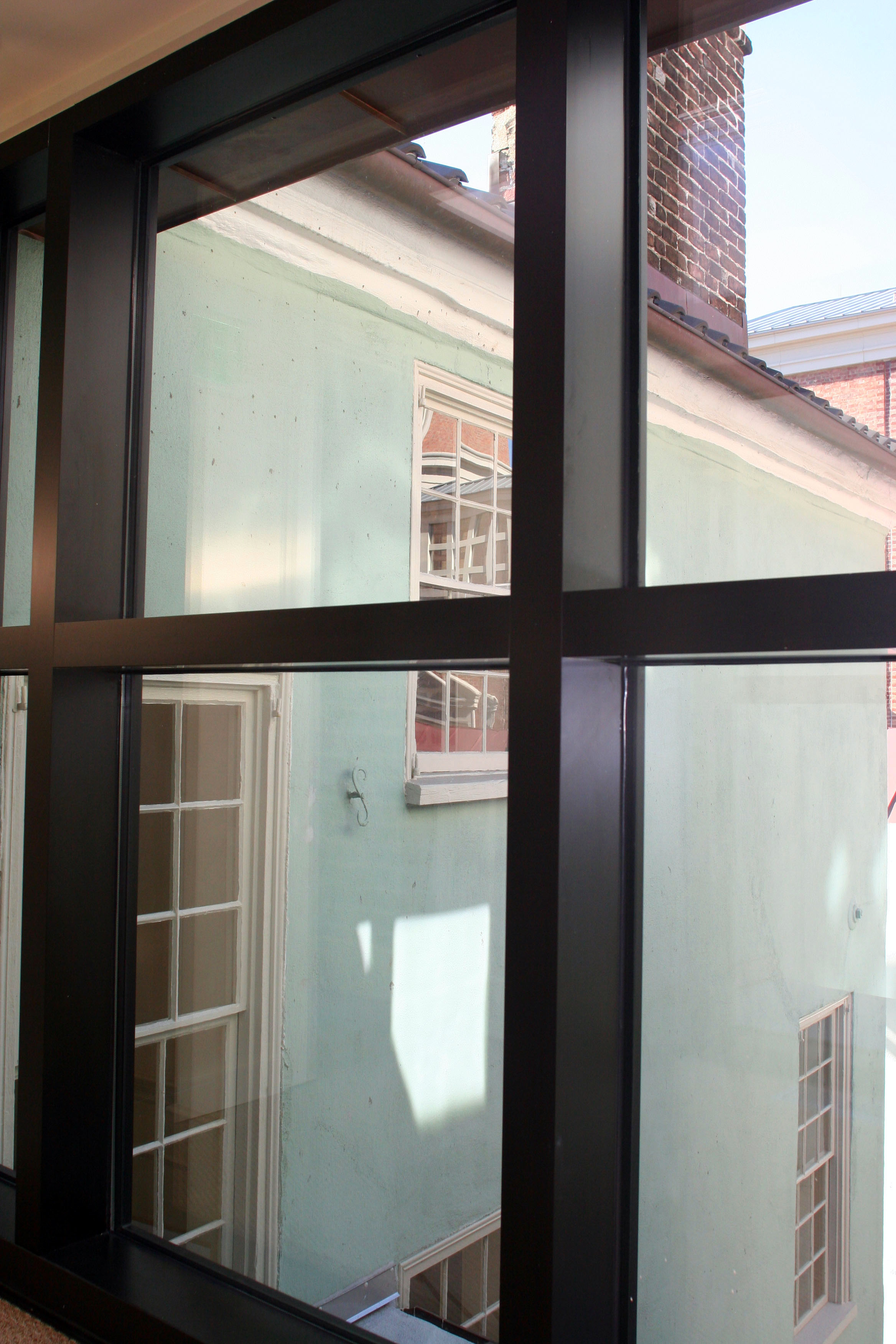 looking through new window to old building